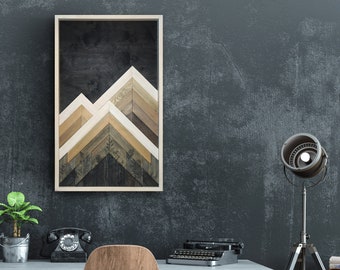 May include: A framed wood art piece with a geometric mountain design in shades of brown, white, and black. The art is hanging on a dark gray wall above a desk with a vintage typewriter, a potted plant, and a black rotary phone.