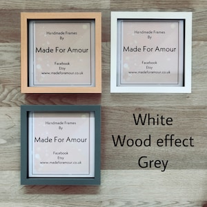 May include: Three picture frames with a white background and text that reads "Handmade Frames By Made For Amour Facebook Etsy www.madeforamour.co.uk". The frames are in three different colors: natural wood, white, and gray. The text "White Wood effect Grey" is below the frames.