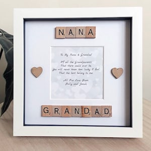 May include: A white picture frame with a gray mat. The frame contains a poem about grandparents and the words "NANA" and "GRANDAD" spelled out with wooden letter tiles.