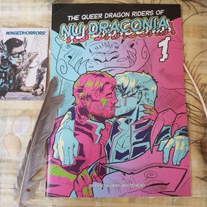 This picture contains the front cover of the comic. It depicts two men kissing, while being embraced by two dragons. The colours are very vivid going from neon pink to neon cyan. The title read'The queer dragon riders of Nu Draconia 1'