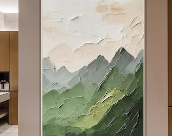 May include: Abstract mountain landscape painting with a textured, impasto style. The artwork features a palette of greens, grays, and whites, creating a sense of depth and dimension. The painting is framed in a white border.