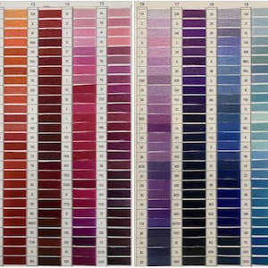 May include: A colour chart showing a wide array of thread colours, arranged in vertical columns. The chart features various shades of red, pink, purple, blue, and green, with each colour sample labelled with a corresponding number.