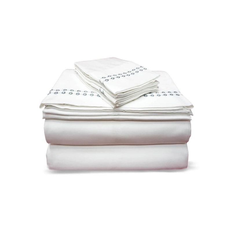 May include: A stack of white bed sheets with a gray embroidered border. The sheets are folded neatly and are ready to be used.