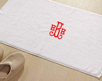 May include: White rectangular bath towel with a red monogram in the center. The towel is made of a soft, absorbent material. The monogram features the letters B, R, and B in a decorative script.