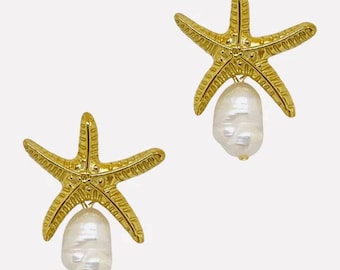 May include: A pair of gold starfish earrings with a pearl dangling from each starfish.