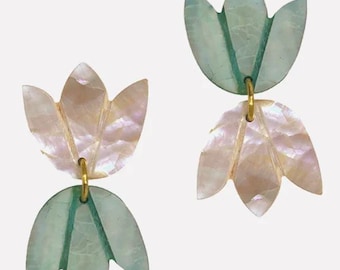 May include: A pair of earrings featuring a double-layered design. The top layer is a light green flower shape, and the bottom layer is a white flower shape.