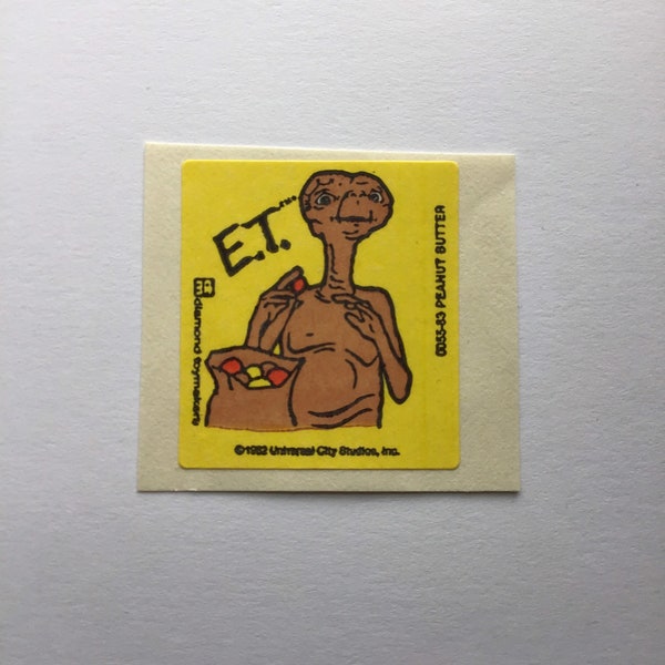 1982 E.T. peanut butter scratch and sniff sticker on original backing. Lightly scented. Listing is for one sticker.