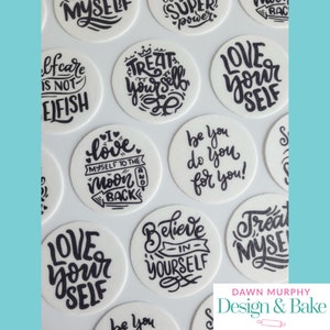 May include: A collection of 12 round white edible cake toppers with black lettering. The toppers feature positive self-love messages such as "Love Yourself", "Treat Yourself", "Be You Do You For You", and "I Love Myself To The Moon And Back".