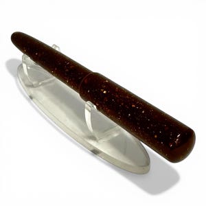 May include: A white ceramic mug with a black handle and the text "But First, Coffee" in a handwritten style. The mug is on a white surface. The mug is approximately 4 inches tall.