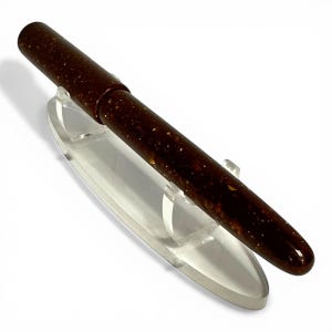 May include: A set of three ceramic mugs with a speckled, matte finish. The mugs are in shades of cream, light gray, and dark gray. Each mug has a simple, minimalist design, perfect for coffee or tea.