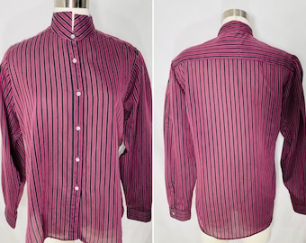 May include: A long-sleeved button-down shirt featuring a vertical striped pattern in dark magenta and black. The shirt has a high mandarin collar, a front button placket with white buttons, and buttoned cuffs, shown from both front and back views.