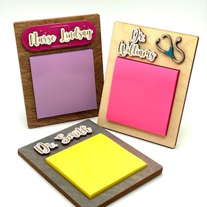 May include: Three wooden notepads with personalized names and medical symbols. The notepads are brown with a light wood finish. The names are "Nurse Lindsay", "Dr. Williams", and "Dr. Smith".