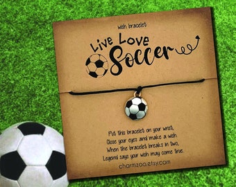 May include: A brown card with the text "Live Love Soccer" and a black string bracelet with a silver soccer ball charm. The card also includes instructions for making a wish with the bracelet. The text "24 Cord Colors" is at the bottom of the card.