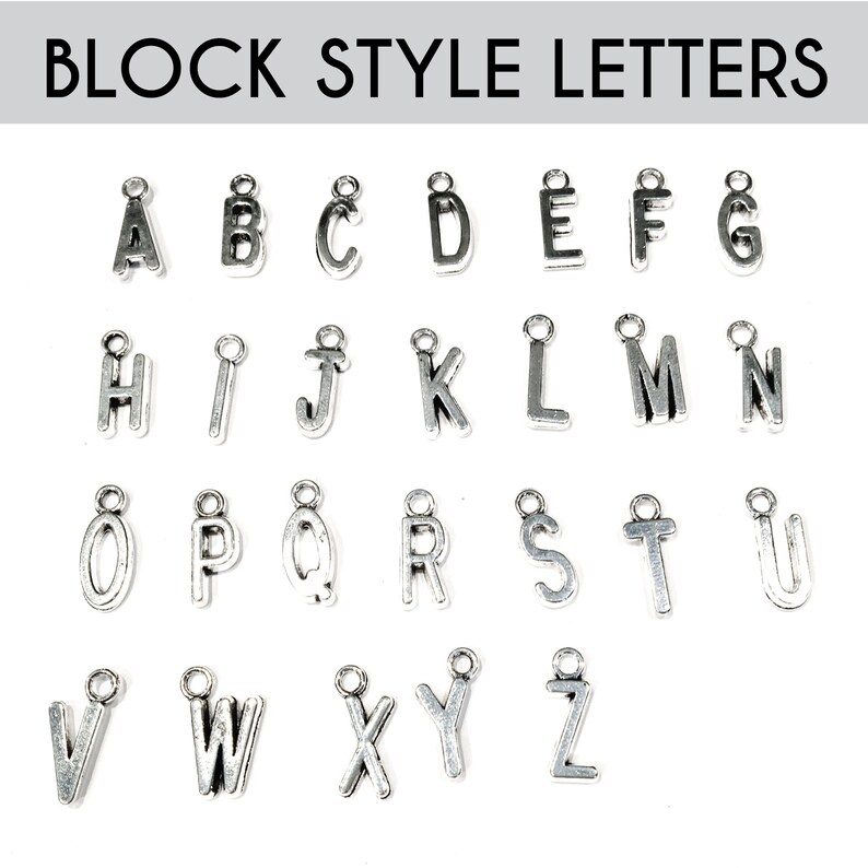 May include: Silver block style alphabet letter charms. The letters are A through Z.