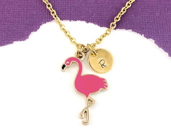 May include: A gold chain necklace with a pink flamingo charm and a gold disc charm with the letter "R" engraved on it.