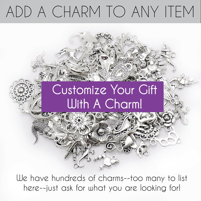 May include: A large pile of silver charms, including flowers, animals, and abstract designs. The text "Customize Your Gift With A Charm!" is displayed on a purple banner.