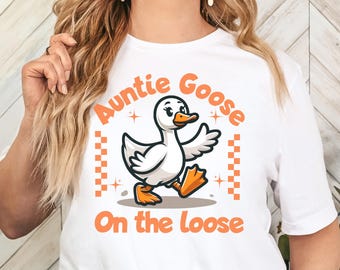 May include: White t-shirt with a cartoon goose and the text "Auntie Goose On the Loose".