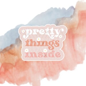May include: A pink sticker with a white daisy pattern and the text "pretty things inside" in a retro font.