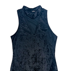 May include: A black sleeveless velvet dress with a mock neck and a sheer mesh panel at the neckline.