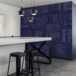 May include: A modern office space with a white countertop and two black bar stools. The wall is covered in a blue wallpaper with a white pattern of text.