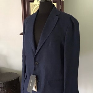 May include: A dark blue blazer with a single button closure and a brand tag that says "Massimo Dutti".