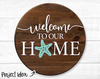May include: A round wooden sign with the text "Welcome to our Home" in white lettering. A teal starfish is centred between the words "Home".