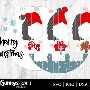 May include: A digital cut file design featuring two gnomes with red hats, candy canes, a gift box, and a gingerbread man. The design includes the text "Merry Christmas".