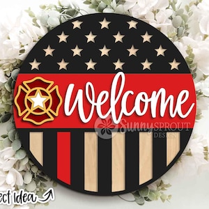 May include: A round wooden sign with a black and red design, featuring white text that reads "Welcome." The top section has black with white stars, and the bottom has vertical stripes. A firefighter emblem is on the left side.