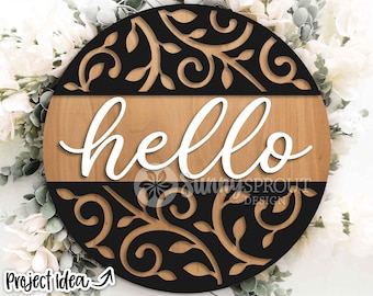 May include: A round wooden sign with a black and white floral design. The sign says "hello" in white lettering.