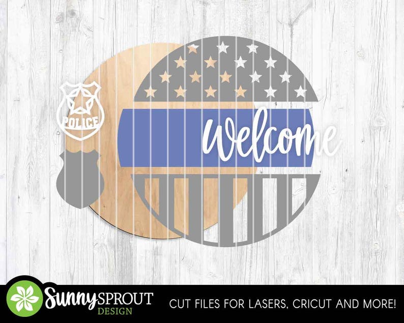 May include: Wooden round sign with a police badge cutout and a design featuring a blue stripe, stars, and the word "Welcome" in white script. The sign is made of natural wood and has a rustic aesthetic.