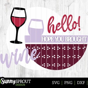 May include: A round, purple and white sign with the text "hello! HOPE YOU BROUGHT wine" and a red wine glass graphic. The background is a burgundy pattern with white dots.
