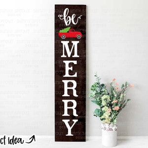May include: A wooden sign with the words "be merry" in white letters. A red truck with a Christmas tree in the back is above the word "merry".