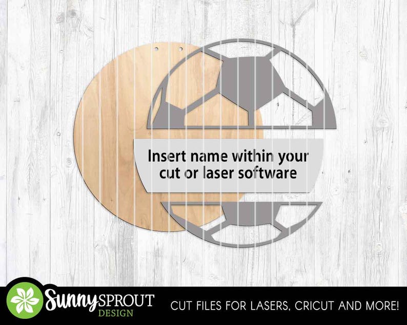 May include: A wooden soccer ball design with a circular wooden background. The design includes a soccer ball outline with a space for a name. Text on the design reads: "Insert name within your cut or laser software."