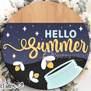 May include: A round wooden sign with a blue background and the text "HELLO summer" in yellow and blue lettering. The sign also features fireflies and a mason jar.