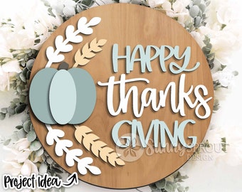 May include: A wooden round sign with the text "HAPPY THANKSGIVING" in white script. The sign is decorated with a light blue pumpkin, wheat stalks, and white leaves.