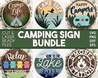 May include: A set of six round wooden signs with various camping-themed designs. The signs feature phrases like "Camp Life", "Lake Life", "Happy Campers", "Relax Sit & Unwind", "Gone to the Lake", and "Smores Station".