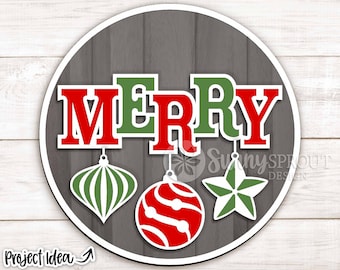 May include: A round wooden sign with the word "MERRY" in red and green letters. There are three hanging ornaments below the word, one red with white stripes, one green with white stripes, and one white star with green points.