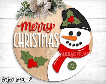 May include: A wooden round sign with the words "Merry Christmas" in white lettering and a red snowman with a black hat, red scarf, and green holly on the side.