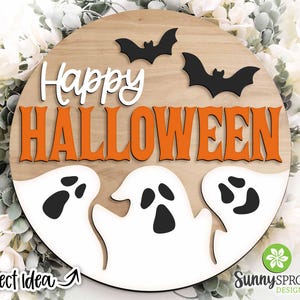May include: A round wooden sign with the words "Happy Halloween" in orange letters. There are three black bats and three white ghosts with black eyes on the sign.