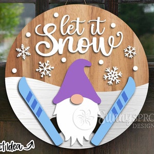 May include: A round wooden sign with the text "Let it Snow" in white lettering. A purple gnome with a white beard is holding two blue skis. The background is white with snowflakes.