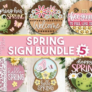 May include: A collection of five spring-themed wooden signs. The signs feature various designs, including a frog, bees, butterflies, and floral elements. Text includes "Spring has Sprung," "Welcome," "It's bee-ginning," and "Hello Spring."