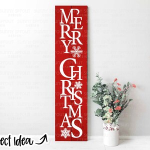 May include: Red wooden sign with white lettering spelling out "Merry Christmas" with snowflakes between each word.