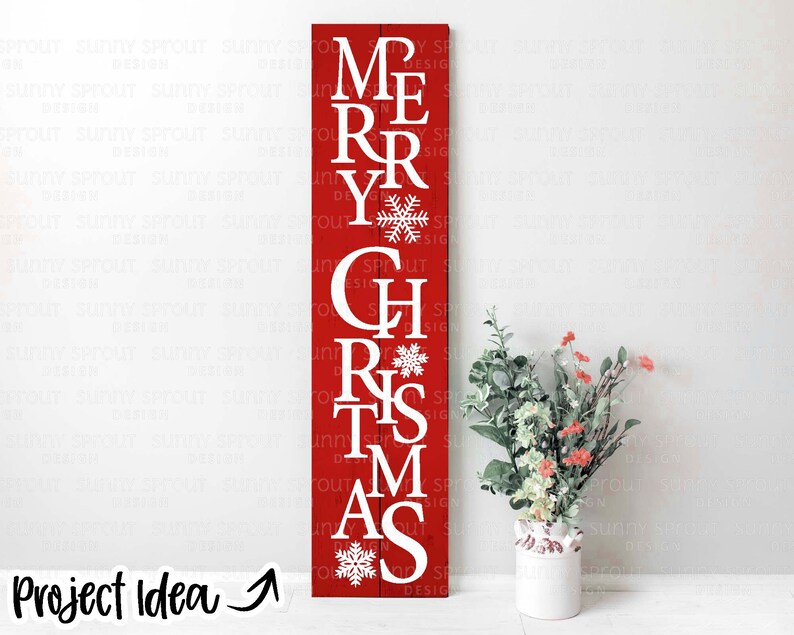 May include: Red wooden sign with white lettering spelling out "Merry Christmas" with snowflakes between each word.