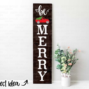 May include: A wooden sign with the words "be merry" in white letters. A red truck with a Christmas tree in the back is above the word "be".