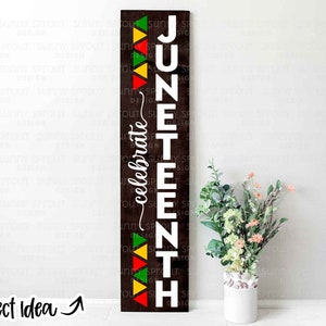 May include: A wooden sign with the words "Juneteenth" and "celebrate" written in white. The sign is decorated with red, yellow, and green triangles.
