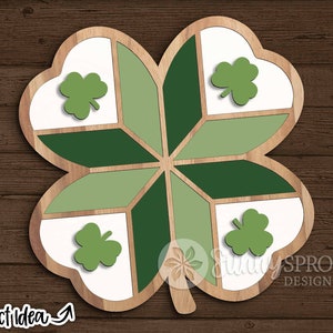 May include: A wooden four-leaf clover with green and white painted sections. Each leaf has a smaller green clover in the centre.