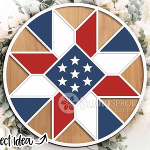 May include: A round wooden wall decor piece with a patriotic design. It features a star pattern in the center with red, white, and blue geometric shapes. The text "Project Idea" is visible in the lower left corner.