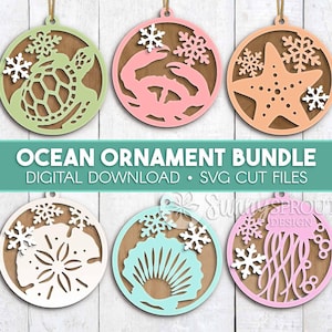May include: A collection of six ocean-themed ornaments in various pastel colors, including a sea turtle, crab, starfish, sand dollar, seashell, and jellyfish. Each ornament features a snowflake design and is suspended by a gold string. The text "OCEAN ORNAMENT BUNDLE" is displayed.