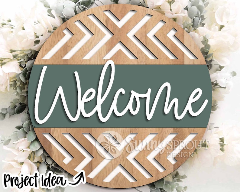 May include: A round wooden sign with a chevron pattern and a green band that says "Welcome".