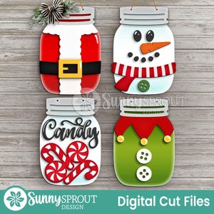 May include: Four wooden mason jar cutouts with Christmas themes. One is Santa-themed with a red suit and gold belt. Another is a snowman with a carrot nose and red scarf. A third says "Candy" with candy canes. The last is an elf.